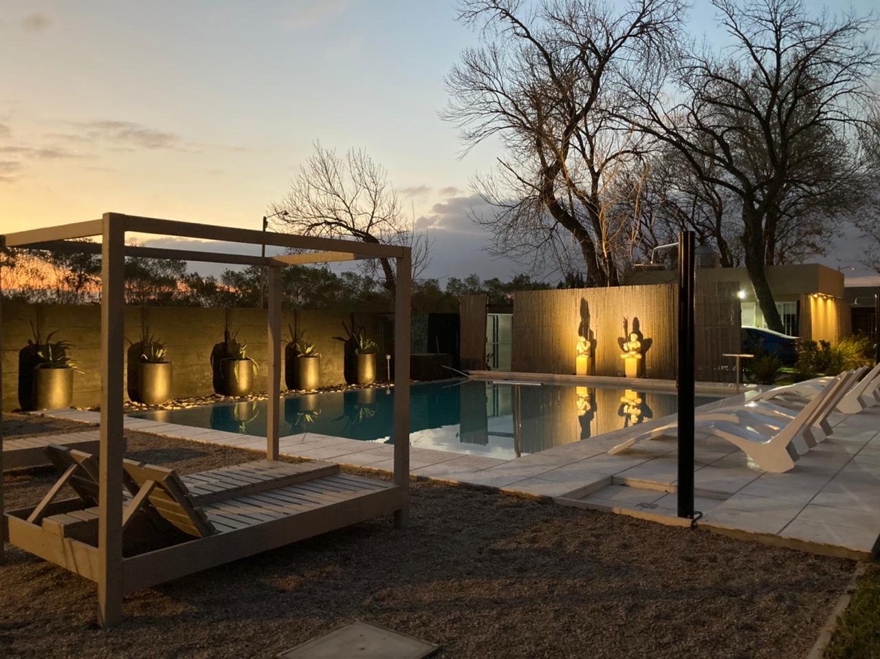 Piscina al atardecer con iluminación – Monte Aromas